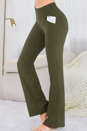 Army green flare-leg performance trousers with side pockets and a phone.