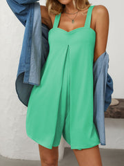 Bright Green pleated bodice romper with wide straps and shorts, styled with a denim shirt.