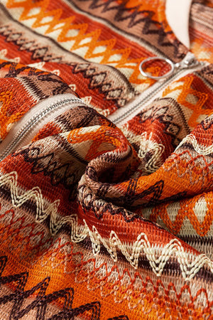 Orange geometric knit bomber jacket with a zipper detail.