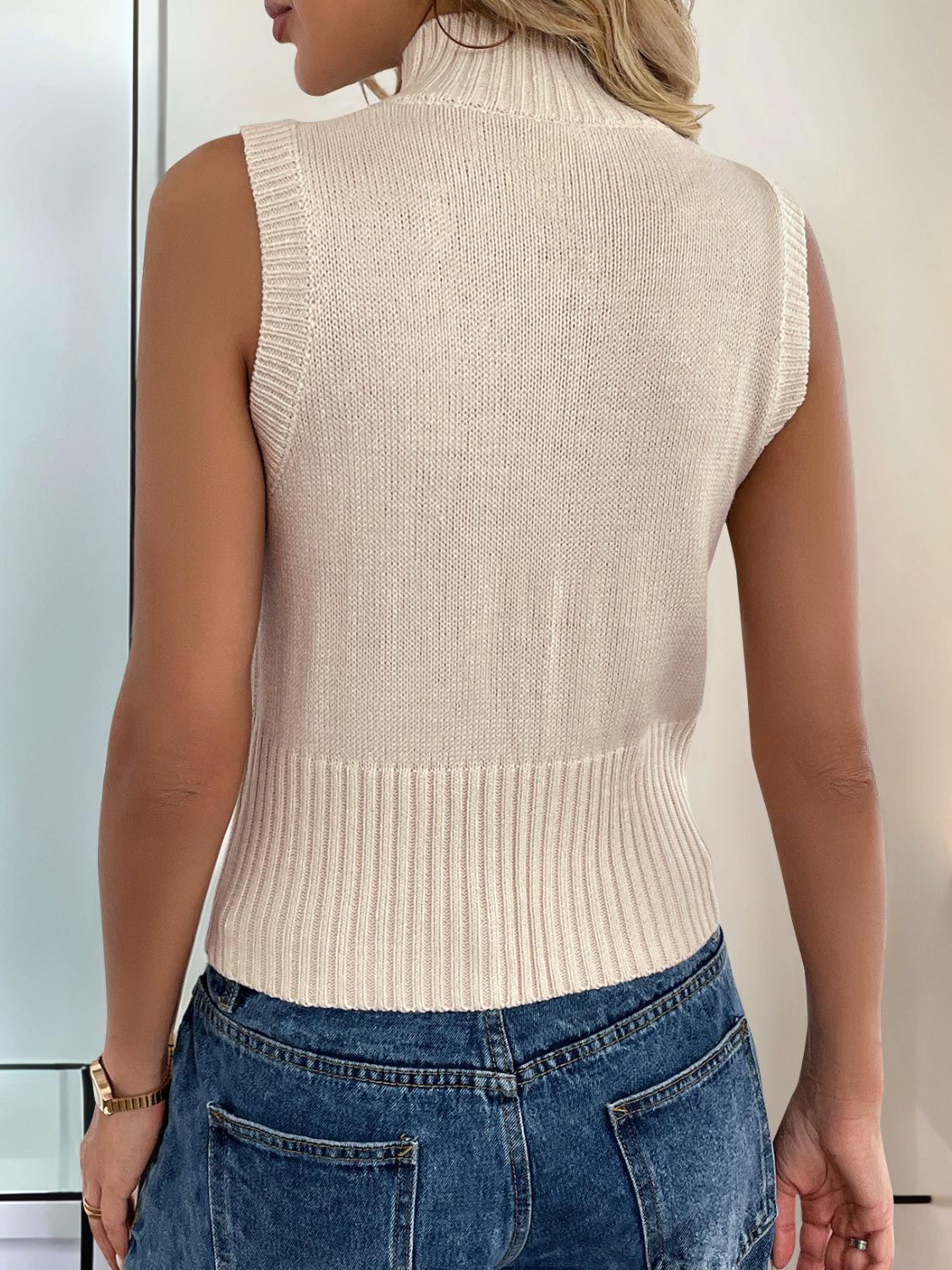 Tan ribbed knit zip-front vest with mock neck and fitted waist