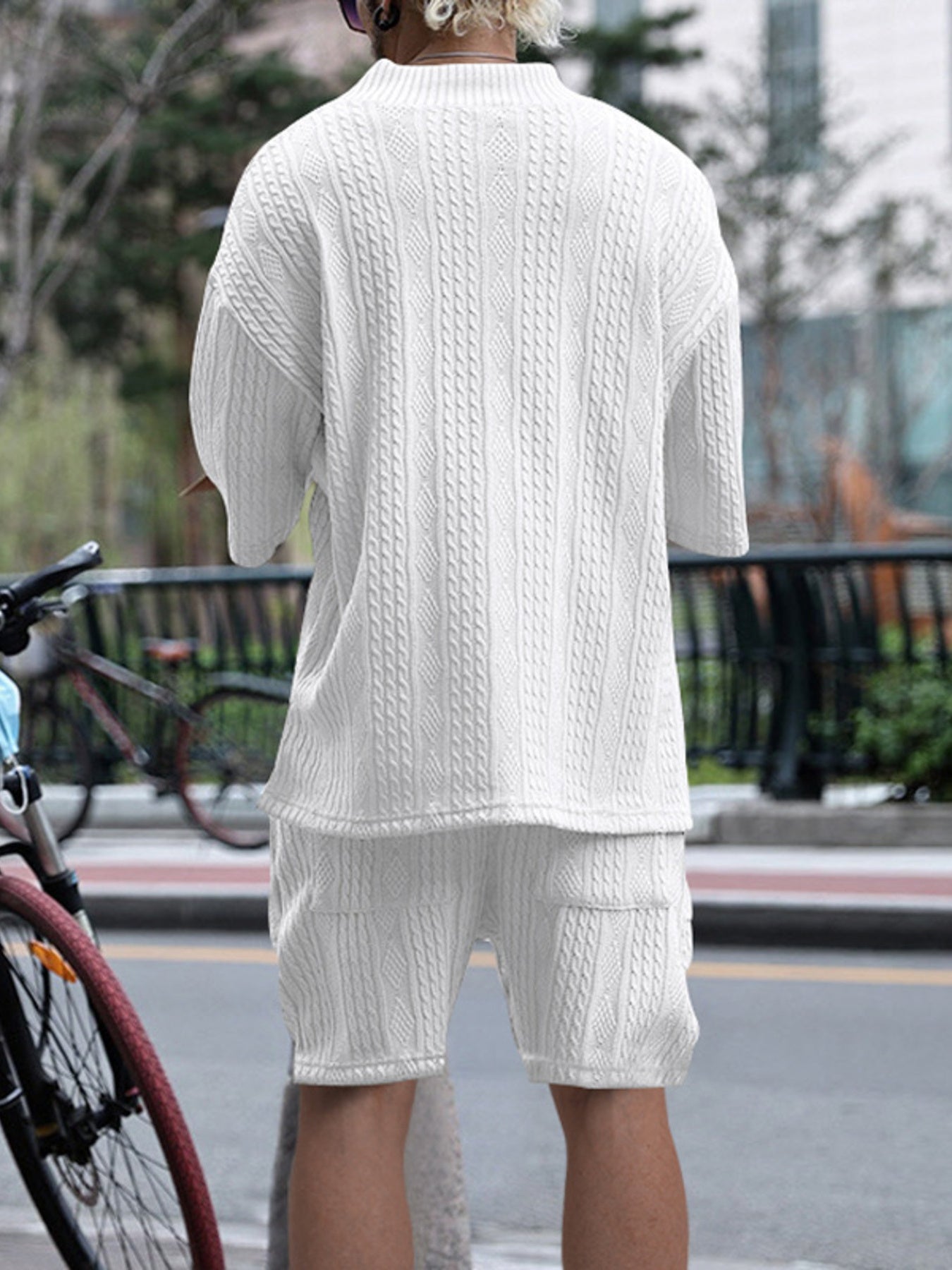 White cable-knit two-piece set with mock neck sweater and shorts.