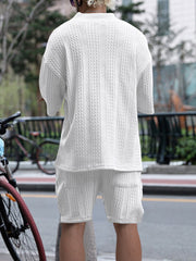 White cable-knit two-piece set with mock neck sweater and shorts.