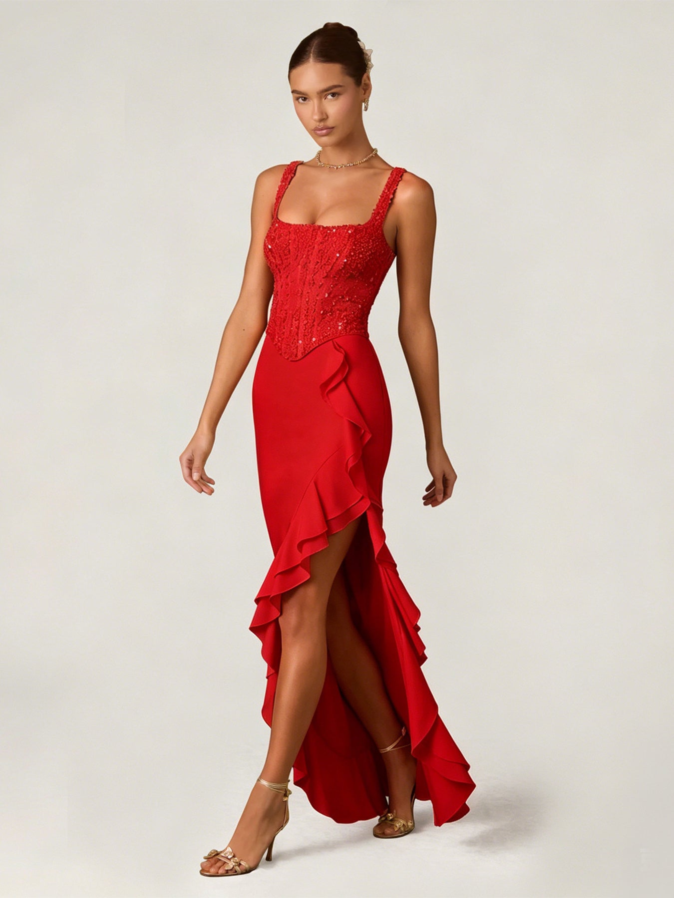 Deep red sequin ruffle maxi gown with square neckline and high slit.