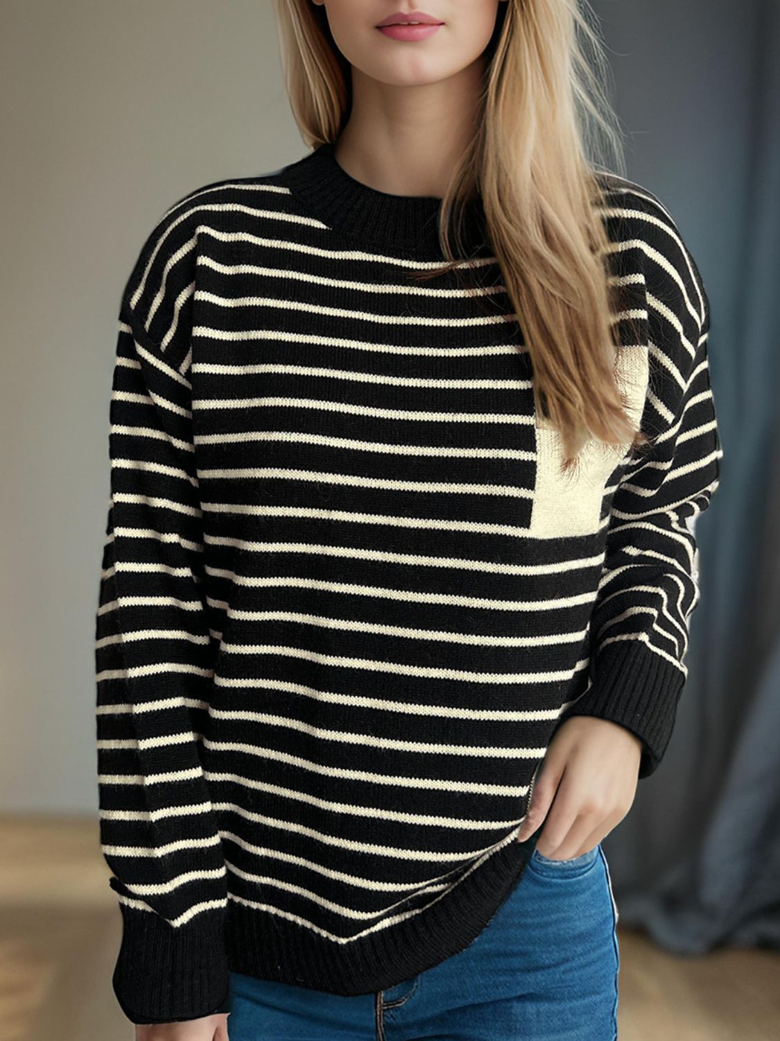 Black and white striped knit sweater with asymmetrical tan pocket detail.