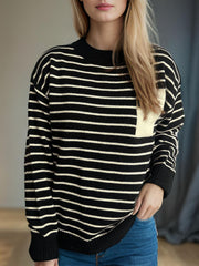 Black and white striped knit sweater with asymmetrical tan pocket detail.