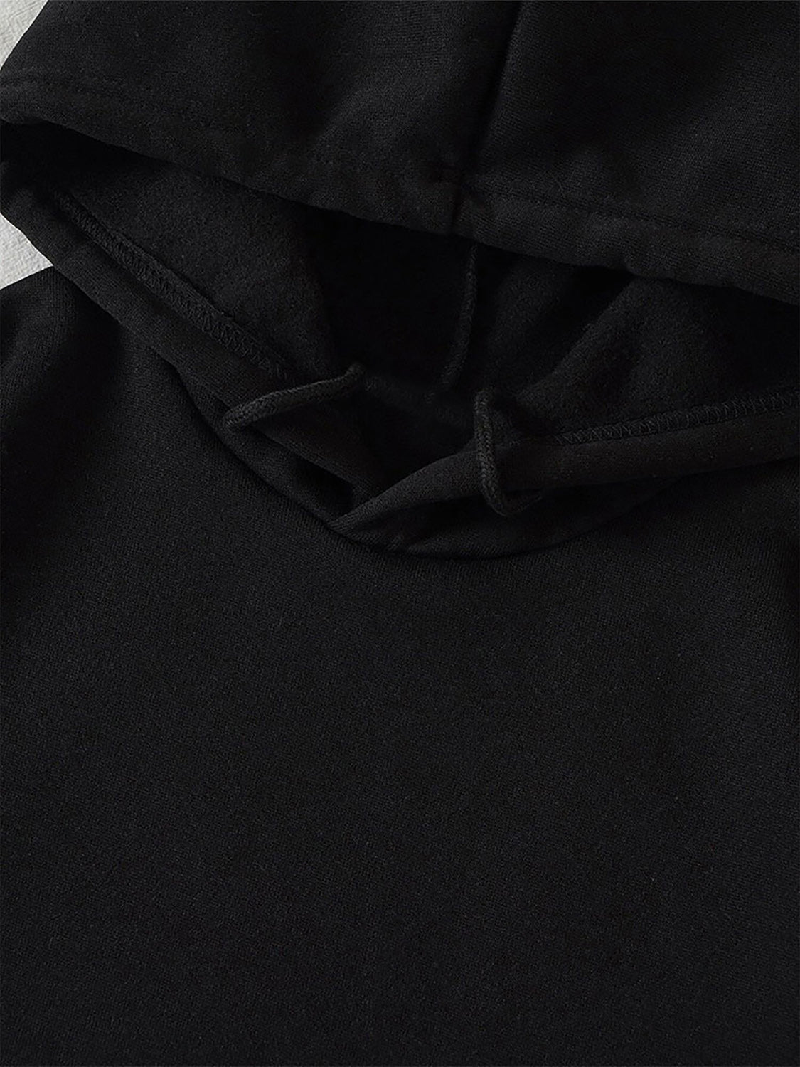 Black hoodie with adjustable drawstring hood and visible stitching detail.