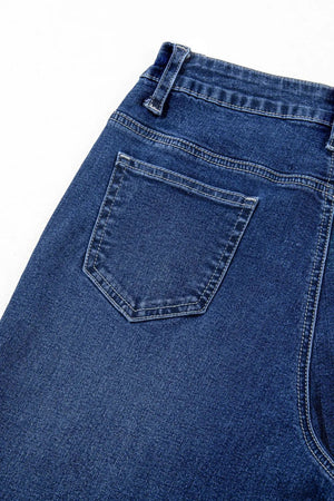 Medium wash denim jeans with a back pocket detail and wide leg cut.