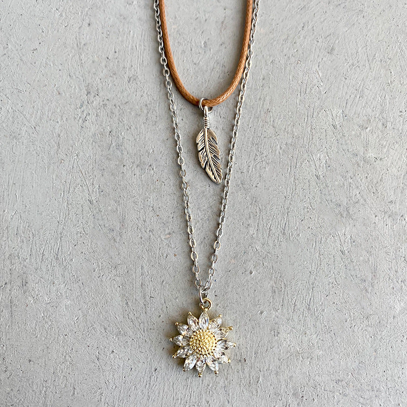 Layered necklace set with sunflower and feather charms, alloy material.