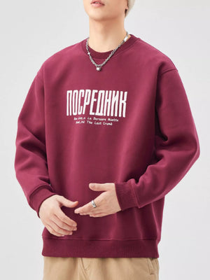 Maroon red oversized graphic sweatshirt with crewneck and ribbed cuffs.