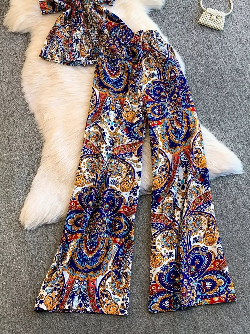 Chic cami and wide-leg pant set in colorful paisley print with smocked top detail.