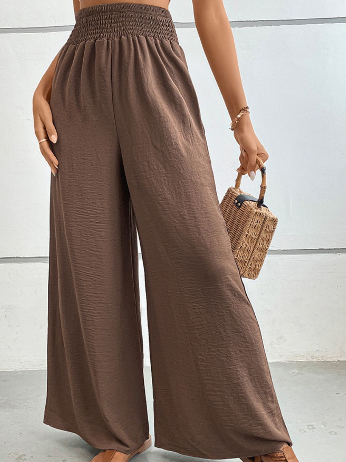 Brown textured smocked waist palazzo maternity trousers with wide legs.
