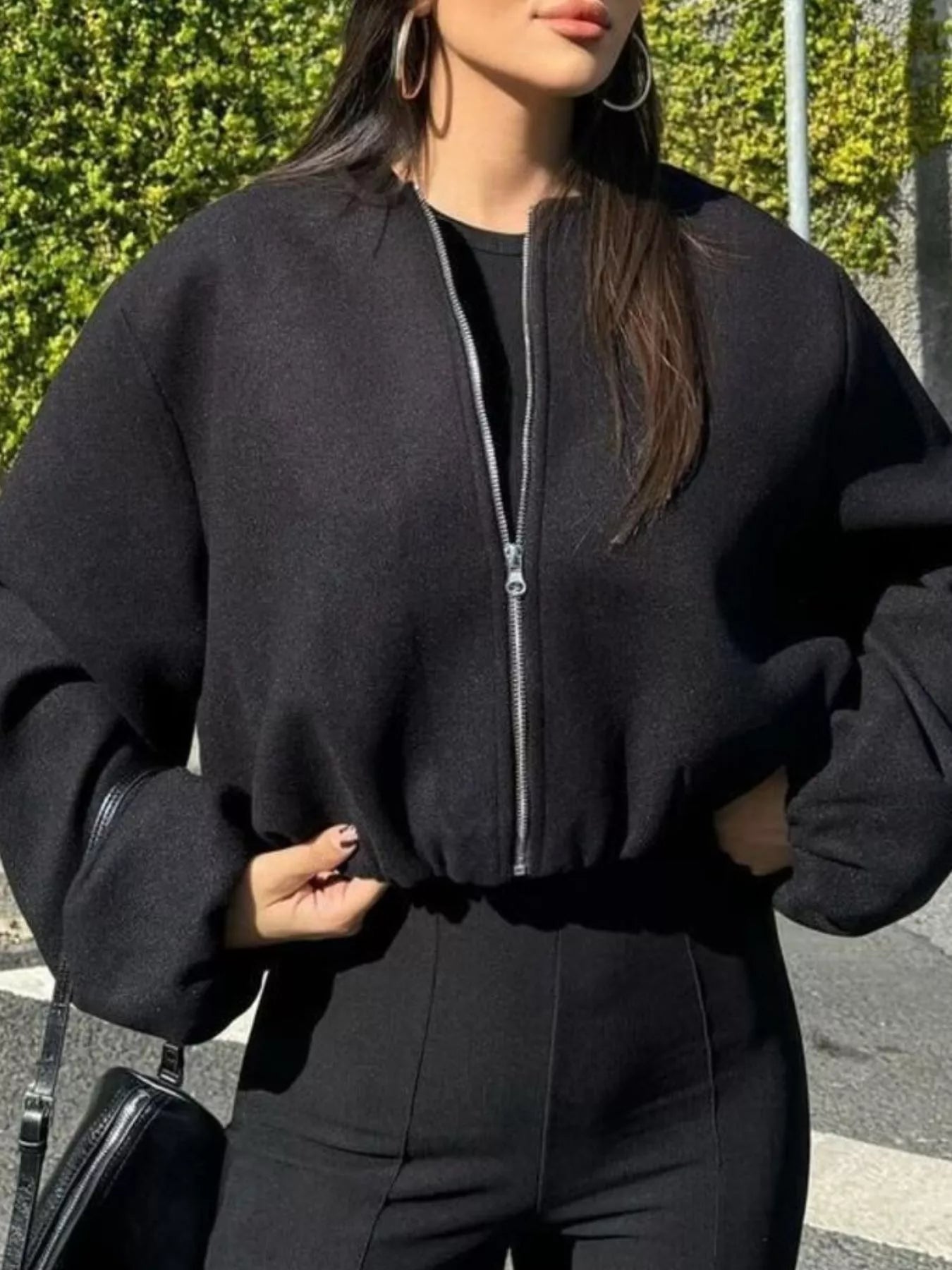Black cropped bomber jacket with zip front and elastic hem