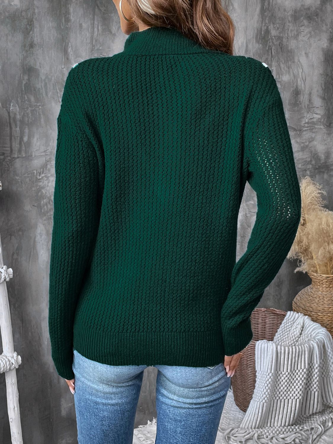 Dark green textured knit sweater with chevron trim and zip neck.