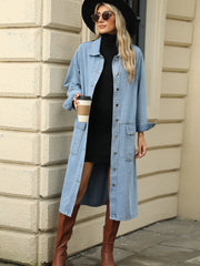 Light blue oversized denim duster jacket with button front and chest pockets.