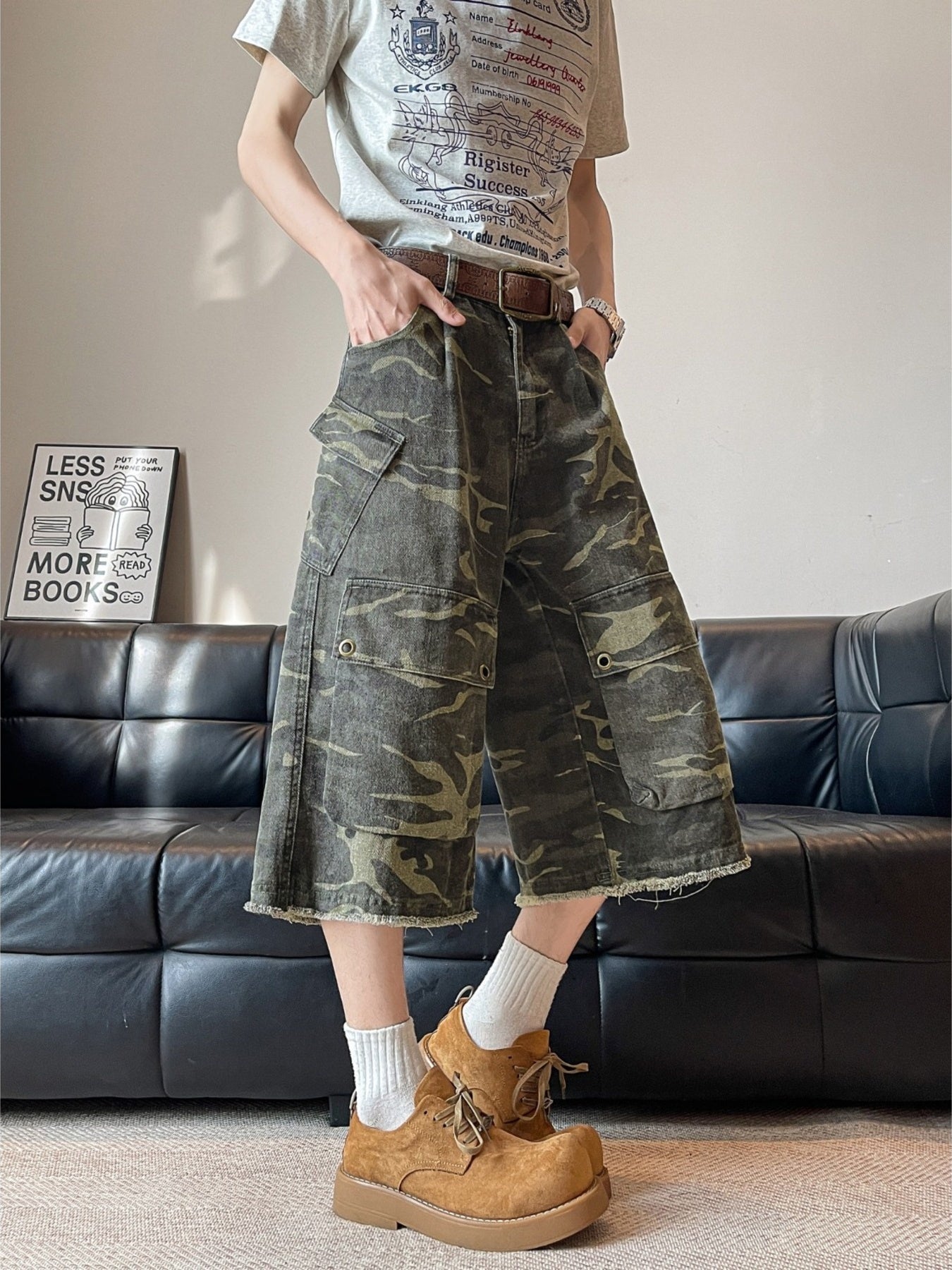Men's vintage camouflage cargo capris with multiple pockets and frayed hem.