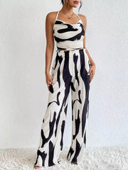 Chic abstract print halter crop top and wide-leg pleated pants set in polyester.