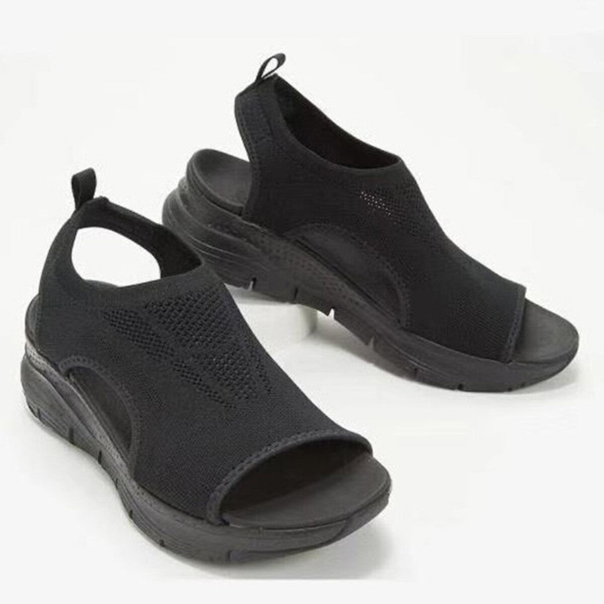 Black breathable open-toe wedge sandals with a chunky sole and slingback strap.