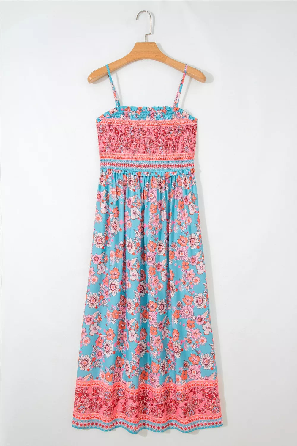 Bohemian floral maxi dress with smocked pink bodice and blue floral print skirt.