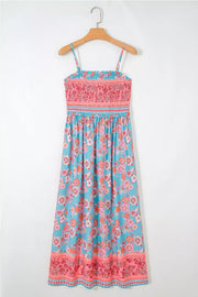 Bohemian floral maxi dress with smocked pink bodice and blue floral print skirt.