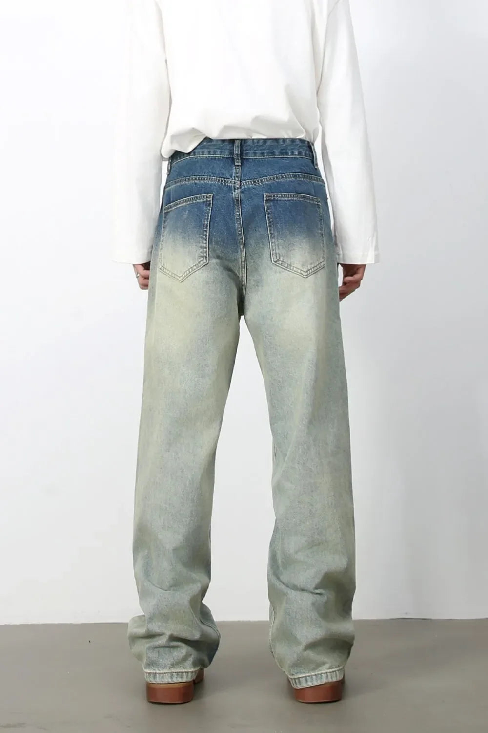 Faded wash wide-leg jeans with drawstring waist and relaxed fit.