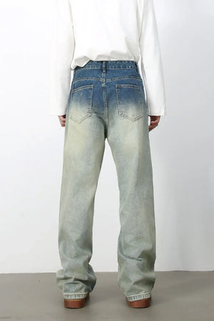 Faded wash wide-leg jeans with drawstring waist and relaxed fit.