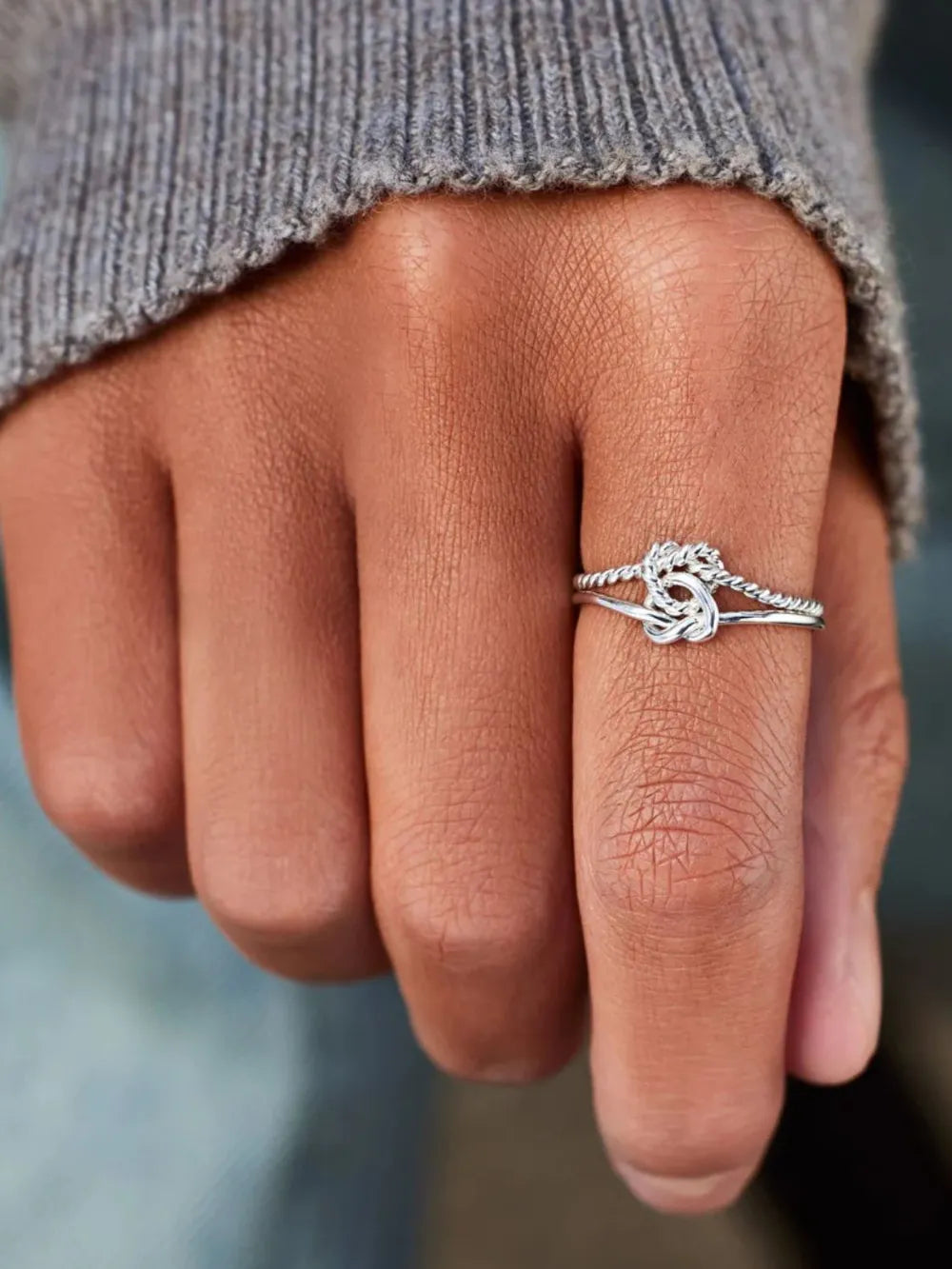 Silver rope knot ring in 925 sterling silver with twisted band detail.
