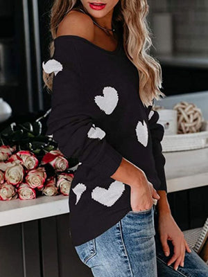 Black raglan knit sweater with white heart motif, off-the-shoulder neckline
