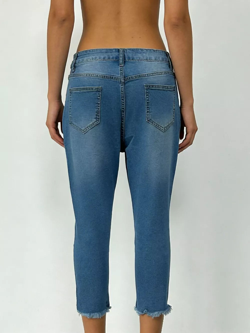 Sky blue cotton capri jeans with raw hem and pockets.