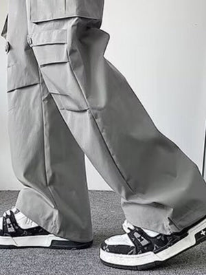 Light gray wide-leg cargo pants with multiple flap pockets and button details.