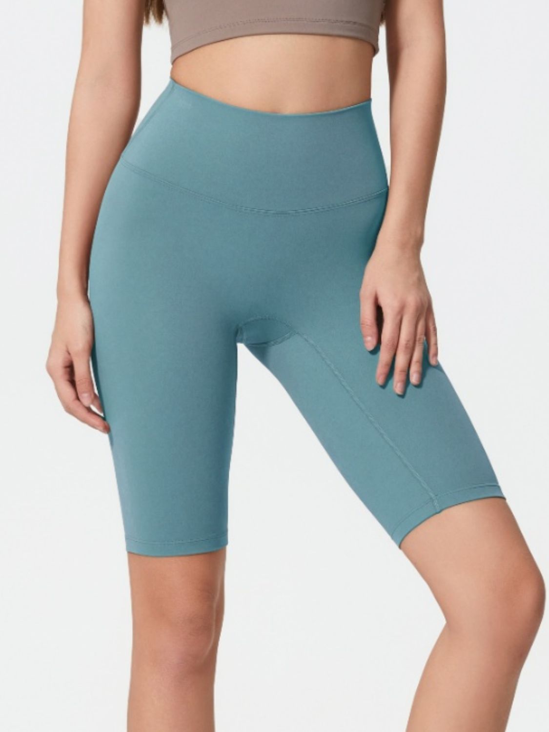 Teal active bike shorts with a high waist and seamless design.