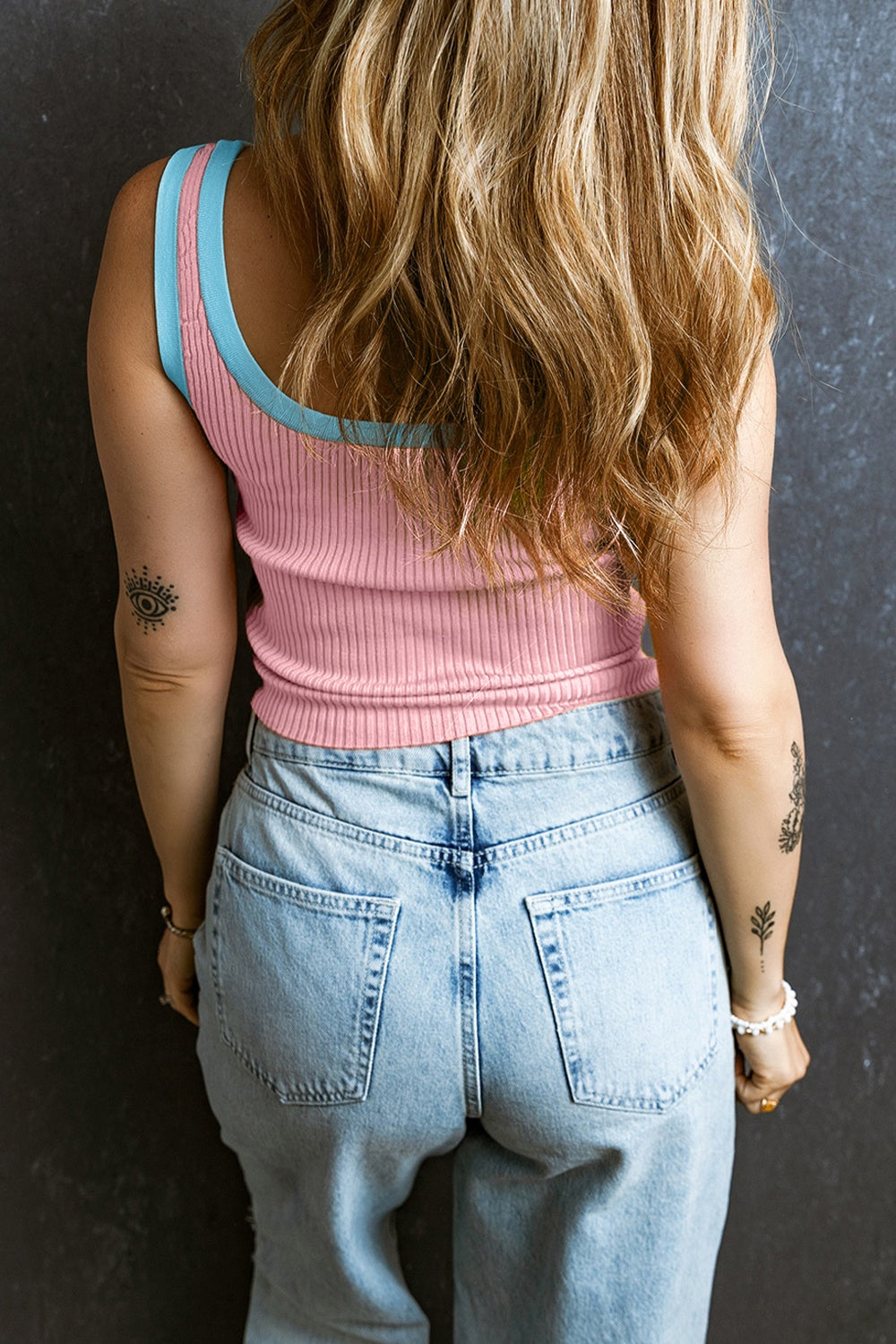 Blush pink ribbed tank top with sky blue contrast trim, styled with light wash jeans.