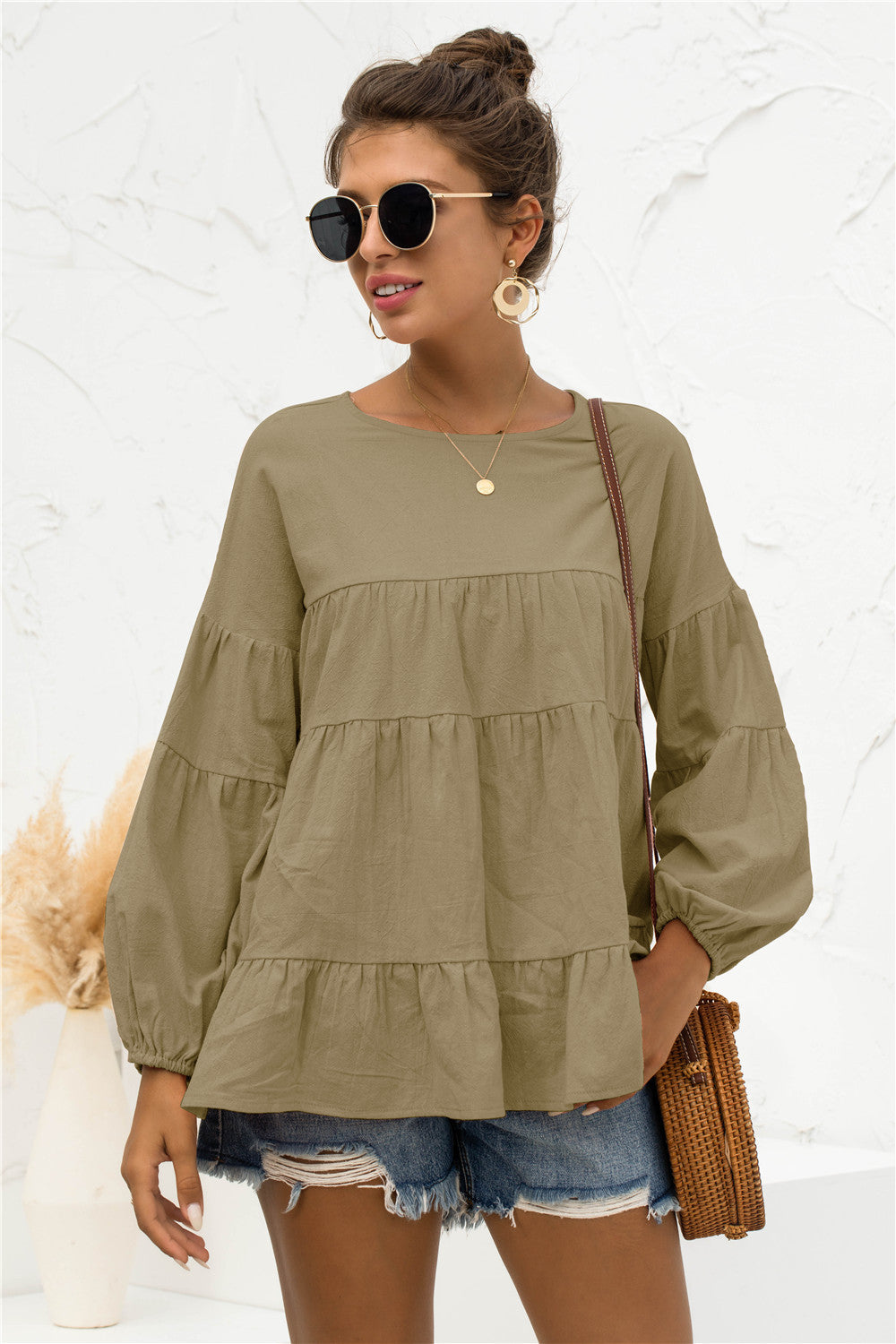 Army green tiered peasant blouse with long balloon sleeves and round neckline.