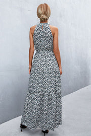 Black floral print maxi dress with halter neckline and tiered skirt.