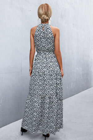 Black floral print maxi dress with halter neckline and tiered skirt.