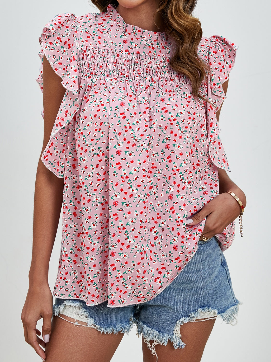 Blush pink floral blouse with smocked yoke and ruffle sleeves