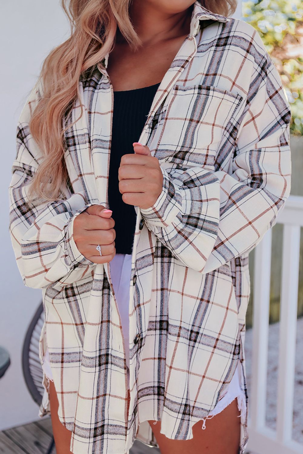 Oversized white plaid shacket with a collared neckline and button front, perfect for casual layering.