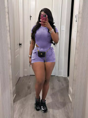 Purple ribbed crop top and shorts set with pockets and chain belt detail.