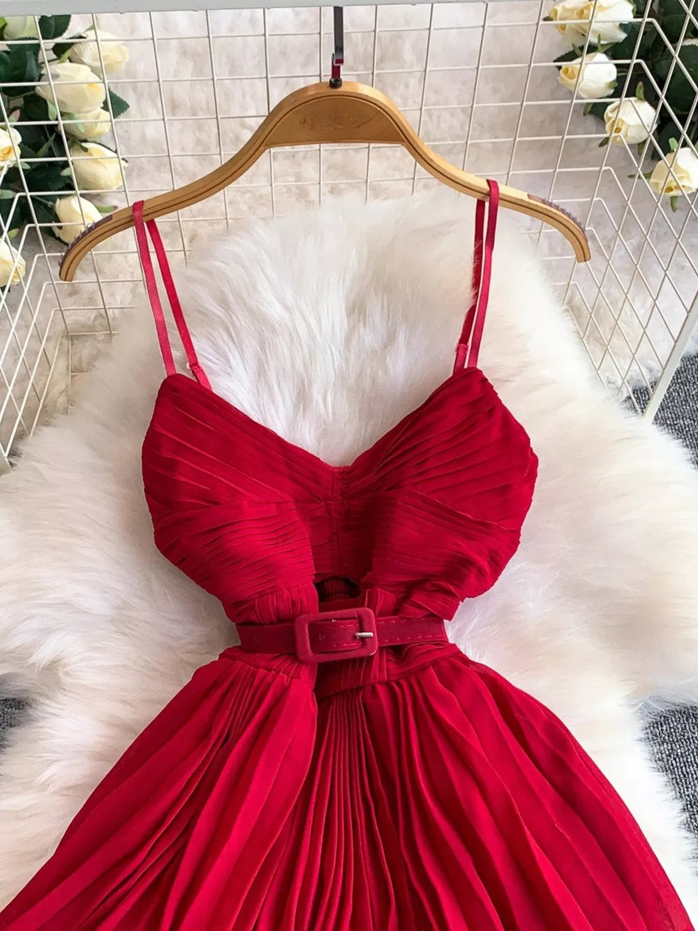 Red belted midi dress with spaghetti straps and pleated skirt
