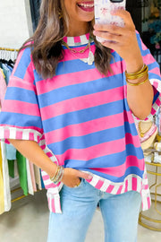 Vibrant striped oversized maternity shirt with patchwork details and rolled cuffs.