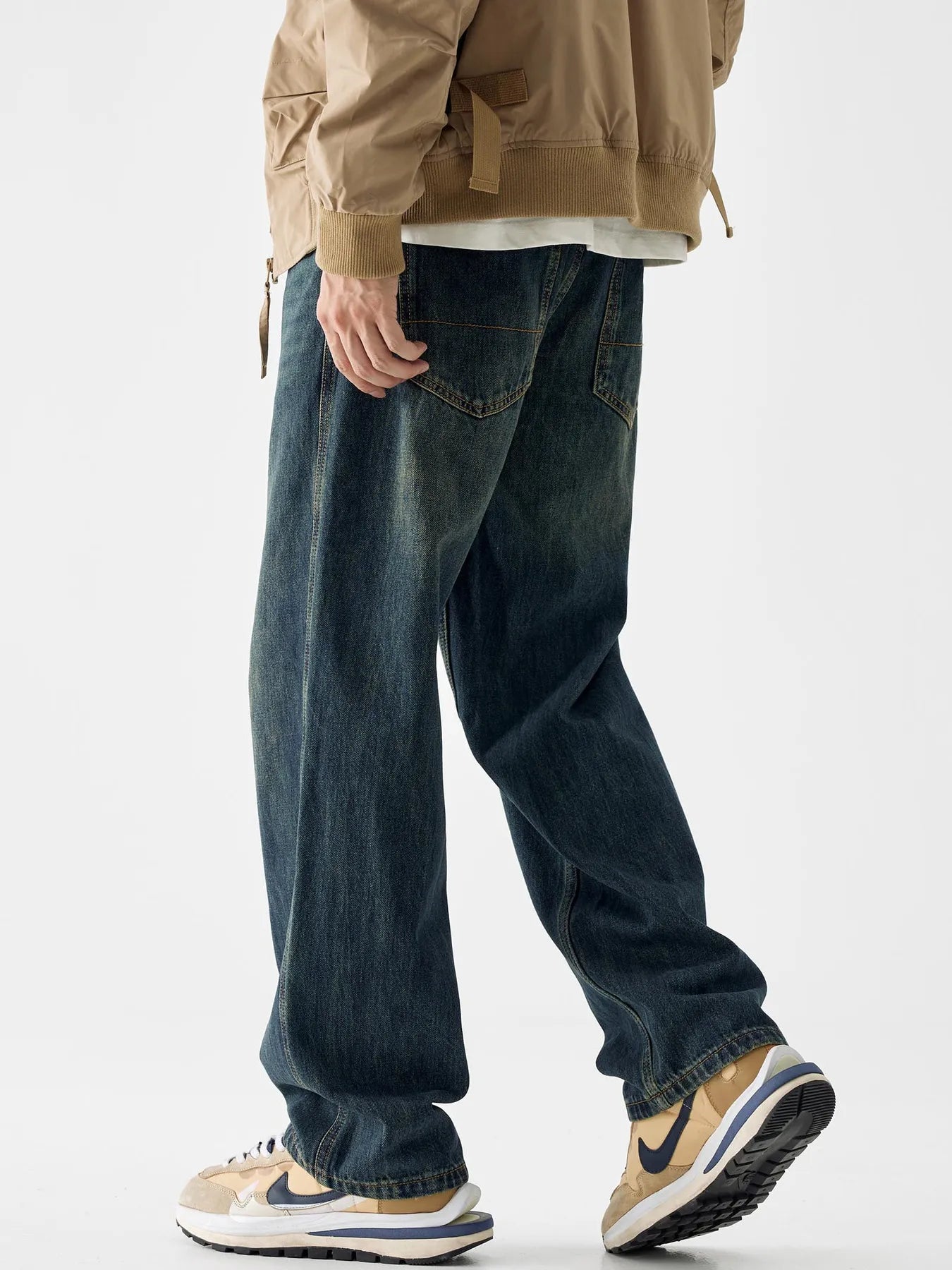 Loose fit blue cotton denim jeans with vintage wash and visible back pockets.