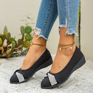 Black slip-on wedge flats with rhinestone bow detail