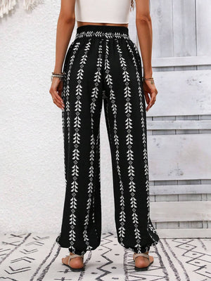 Black ankle trousers with white leaf print and gathered cuffs.