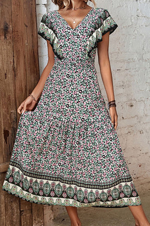 Bohemian floral midi dress in viscose with butterfly sleeves, smocked waist, and tiered skirt with ornate border.