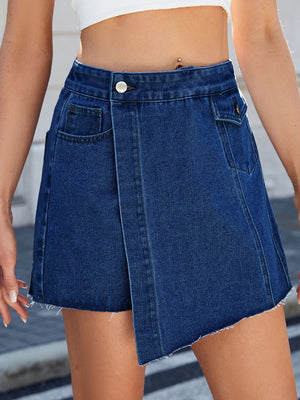 Dark wash denim skort with asymmetric wrap front and raw hem