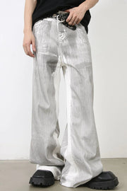 Metallic panel wide leg trousers in light with a distressed, abstract pattern.
