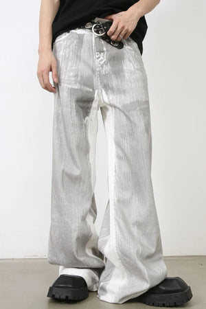 Metallic panel wide leg trousers in light with a distressed, abstract pattern.