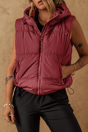 Burgundy quilted hooded puffer vest with drawcord hem and zip pockets.