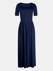 Dark blue textured wide-leg jumpsuit with short sleeves and subtle elastic waist
