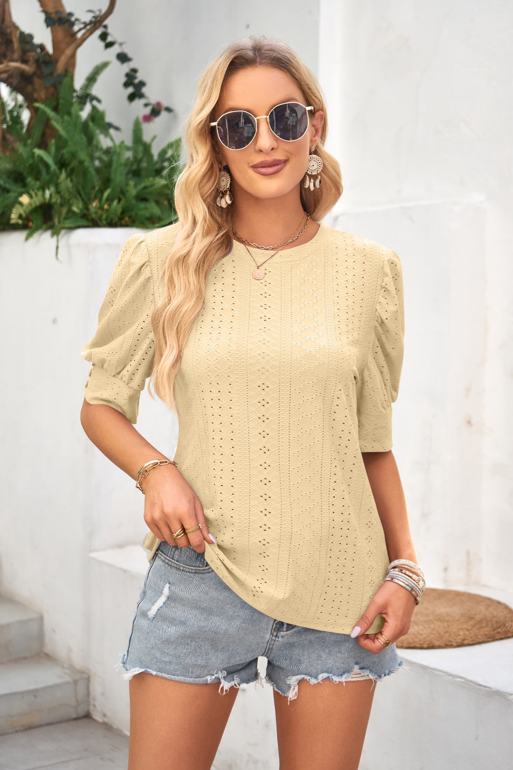 Light Yellow eyelet puff sleeve blouse with crew neck and short sleeves.