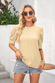 Light Yellow eyelet puff sleeve blouse with crew neck and short sleeves.